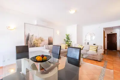 a living room with a table and a couch at Villa Arrifes by Atlantic Places in Albufeira