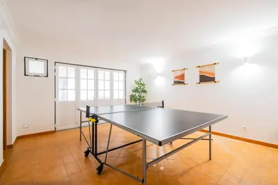 a ping pong table in the middle of a room at Villa Arrifes by Atlantic Places in Albufeira