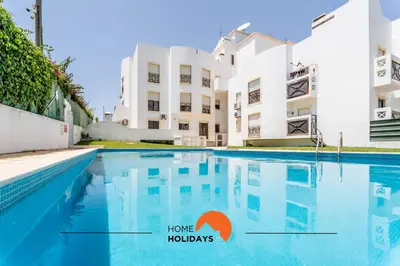 a swimming pool in front of a building at #180 T2 Ondas do Mar by Home Holidays in Albufeira