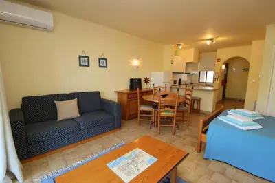 a living room with a couch and a table at Studio Camélia 67 at São Rafael Beach - Albufeira in Albufeira