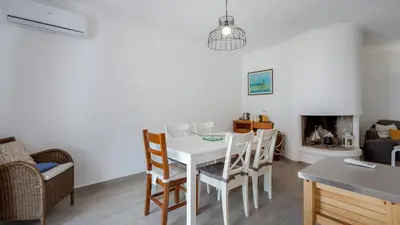 a kitchen and living room with a table and chairs at 1 BDR Vilamoura Escape W Patio by LovelyStay in Quarteira