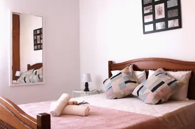 a bedroom with a bed with a teddy bear on it at Casa do Limoeiro in Albufeira