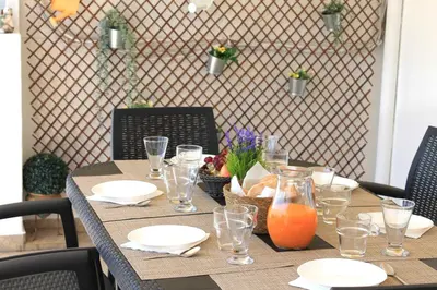 a table with plates and glasses on top of it at Casa do Limoeiro in Albufeira