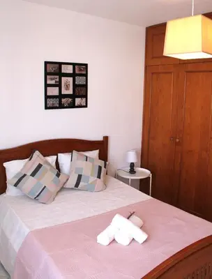 a bedroom with a bed with two towels on it at Casa do Limoeiro in Albufeira