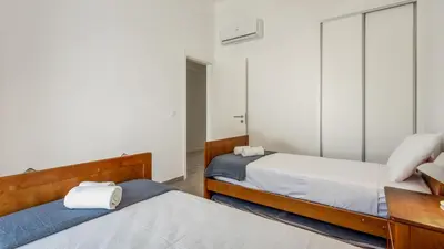 a bedroom with two beds and a mirror at 2 BDR Vilamoura Escape W Balcony by LovelyStay in Quarteira