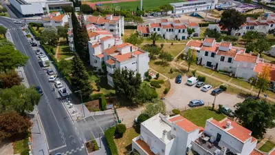 an aerial view of a city with houses and cars at 2 BDR Vilamoura Escape W Balcony by LovelyStay in Quarteira