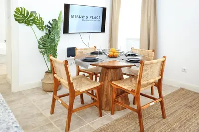 a dining room with a wooden table and chairs at Doce Faro Niente Apartment in Faro