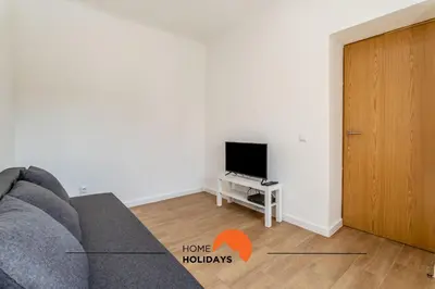 a living room with a couch and a tv at #178 Monte das Churras 1 by Home Holidays in Albufeira