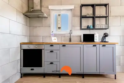 a kitchen with a counter with an orange arrow pointing to a stove at #179 Monte das Churras 2 by Home Holidays in Albufeira