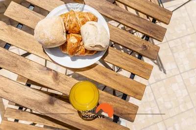 a plate of bread and a yellow cup on a table at #179 Monte das Churras 2 by Home Holidays in Albufeira