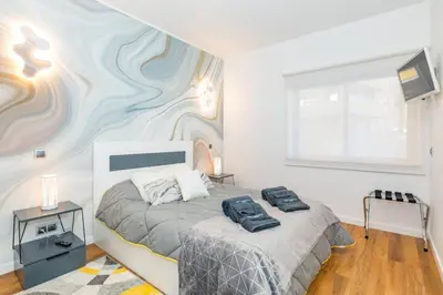 a bedroom with a bed with two bags on it at Stunning Exclusive Parque Atlântico in Quarteira