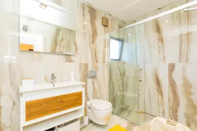 a bathroom with a shower and a toilet and a sink at Stunning Exclusive Parque Atlântico in Quarteira