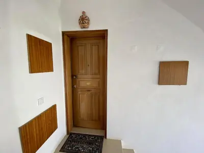 a door in a white wall with a rug next to it at Vilamoura Twins 2 With Pool by Homing in Vilamoura