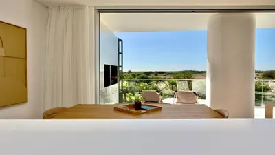 a room with a table and chairs and a large window at Lake24 CD256- CleverDetails, 3 bedroom apartment, sleeps 6, near to Falesia Beach and the Marina in Vilamoura
