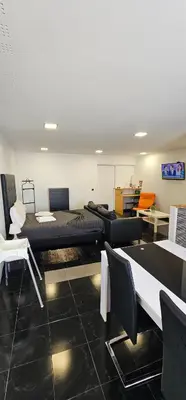 a room with two beds and tables and chairs at Original Apartments in Albufeira