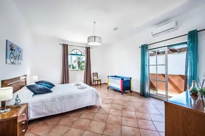 a bedroom with a bed and a table and a window at Villa Luis in Galé