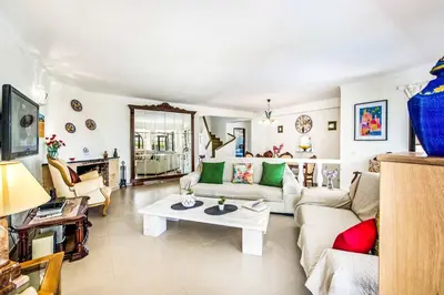 a living room with a couch and a table at Villa Toad Hall in Galé