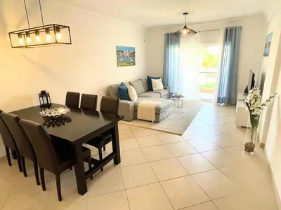 a living room with a table and a couch at Praia Village AG in Vilamoura