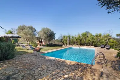 a swimming pool in a yard with trees and a house at Casa Palma in Paderne