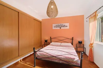 a bedroom with a bed and a pendant light at Casa Palma in Paderne