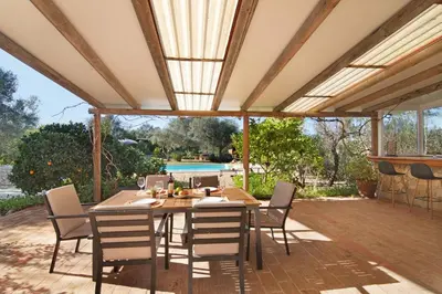 an outdoor dining room with a table and chairs at Casa Palma in Paderne