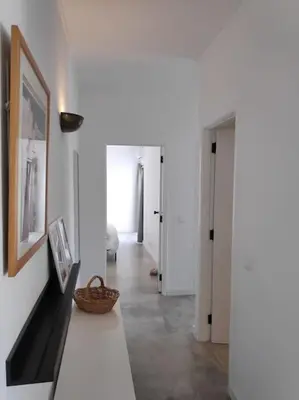 a white room with a table and a hallway at Airy 3br, AC, Garden, 2min Strip, 8min Oura Beach in Albufeira
