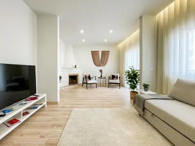 a living room with two chairs and a plant at Loulé Sunny Retreat by LovelyStay in Loulé