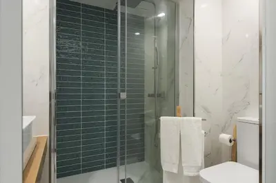 a bathroom with a glass shower with a toilet at Miral 5 Sea front by HD Properties in Quarteira