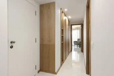 a hallway with white walls and wooden doors at Miral 5 Sea front by HD Properties in Quarteira