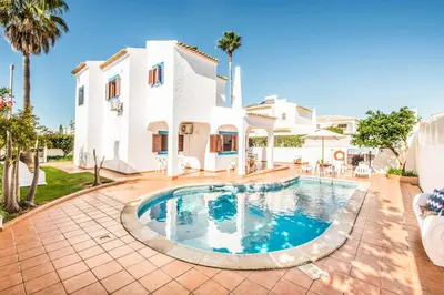 a villa with a swimming pool in front of a house at Villa Mar Gale in Galé