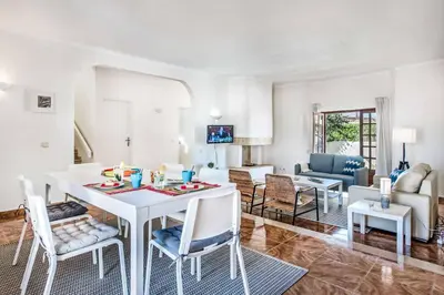 a living room with a white table and chairs at Villa Mar Gale in Galé