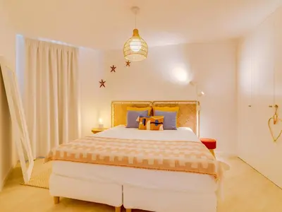 a bedroom with a large bed and a pendant light at AL - Vilamoura Algardia in Vilamoura