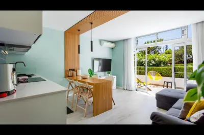 a kitchen and living room with a table and chairs at Ocean Oasis by LovelyStay in Albufeira
