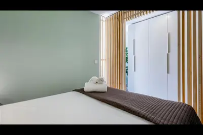 a bedroom with a bed with two towels on it at Ocean Oasis by LovelyStay in Albufeira