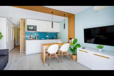a kitchen with a table and two white chairs at Ocean Oasis by LovelyStay in Albufeira