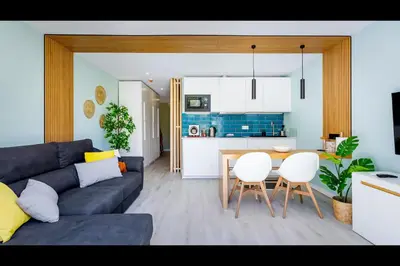 a living room with a couch and a table and chairs at Ocean Oasis by LovelyStay in Albufeira