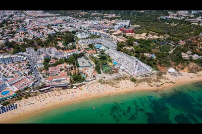an aerial view of a beach with people and the ocean at Ocean Oasis by LovelyStay in Albufeira