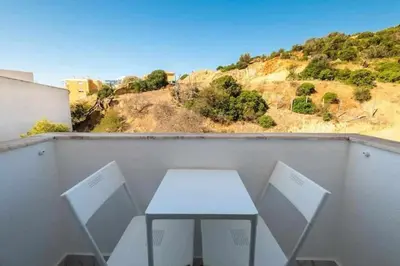 a white table and two chairs on a balcony at Downtown Art Flat in Albufeira