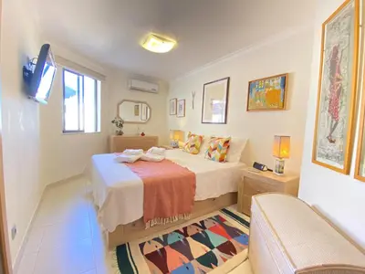 a bedroom with a bed and a tv and a couch at Vilamoura Central 7 With Pool by Homing in Vilamoura