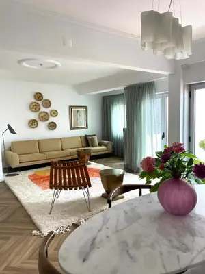 a room with windows and chairs and a plant at Loulé Old Town Apartment in Loulé