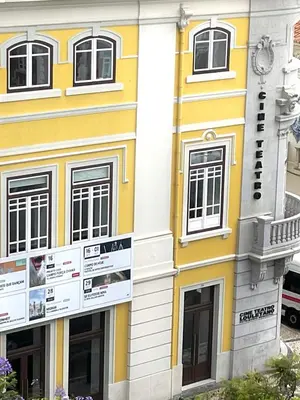 a balcony with two chairs and a view of a city at Loulé Old Town Apartment in Loulé