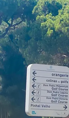 a sign in front of a body of water at Solar Dos Pinheiros in Quarteira
