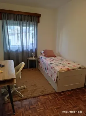 a bedroom with a bed and a desk and a window at The Retreat - O Retiro Algarvio in Faro