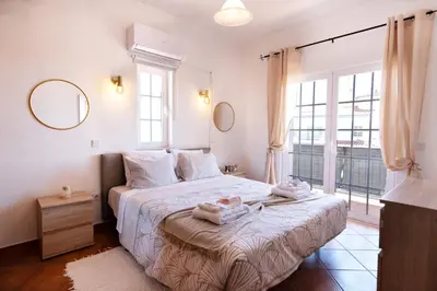 a bedroom with a bed with two towels on it at Villa Luz Vieira in Albufeira