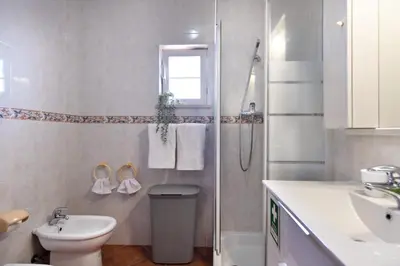 a bathroom with a shower and a toilet and a sink at Villa Luz Vieira in Albufeira