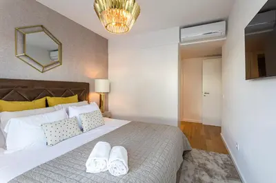 a bedroom with a large bed with two white towels at The Albufeira Concierge - Prime Lounge Design in Albufeira