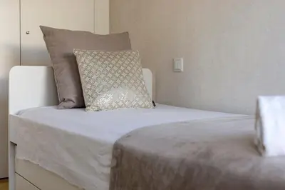 a bed with a pillow on top of it at The Albufeira Concierge - Prime Lounge Design in Albufeira