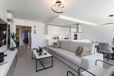 a white living room with a couch and a table at The Albufeira Concierge - Prime Lounge Design in Albufeira