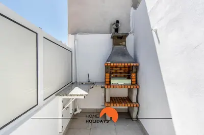 a balcony with a stove on the side of a building at #163 Dr José Silva 17 by Home Holidays in Albufeira