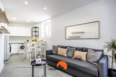 a living room with a couch and a kitchen at #163 Dr José Silva 17 by Home Holidays in Albufeira